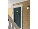 Condo building entry door with a simple design and number 513 at 10024 Strafford Oak Ct # 815, Tampa, FL 33624