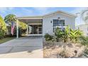 Gray mobile home with covered porch and landscaped yard at 3836 Chris Dr, Wesley Chapel, FL 33543