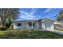 Charming house with newly landscaped lawn, attached garage, and light colored walls at 1722 St Croix Dr, Clearwater, FL 33759