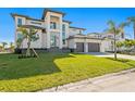 Beautiful home with a manicured lawn and three-car garage, featuring a modern architectural design at 1940 Hawaii Ne Ave, St Petersburg, FL 33703