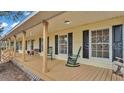 Inviting covered front porch featuring rocking chairs, comfortable seating, and classic home design at 1315 Cowart Rd, Plant City, FL 33567
