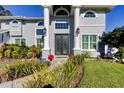 Elegant entryway with double doors, lush landscaping, and architectural columns at 436 Lafayette Blvd, Oldsmar, FL 34677