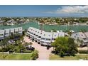 Aerial view showcasing condo building, parking, and waterfront location at 370 Pinellas Bayway S # E, Tierra Verde, FL 33715