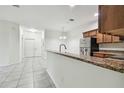 Kitchen features granite counters and wood cabinets at 2632 River Preserve Ct, Bradenton, FL 34208