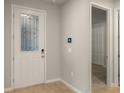 Front entry with white door, glass accents, and tile flooring at 20363 Symphony Pl, Venice, FL 34293