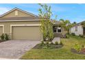 Two-car garage home with walkway and nicely landscaped front yard at 20363 Symphony Pl, Venice, FL 34293