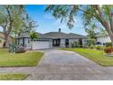 Beautiful waterfront home with a large driveway and lush landscaping at 6613 Seabird Way, Apollo Beach, FL 33572