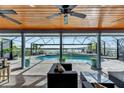 Relaxing pool area with water view, covered patio, and comfortable seating at 6613 Seabird Way, Apollo Beach, FL 33572