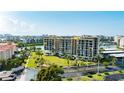 Aerial view of a condo building near the water with lush landscaping at 7400 Sun Island Dr # 501, South Pasadena, FL 33707