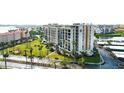 Aerial view highlighting condo building, palm trees, and roadside at 7400 Sun Island Dr # 501, South Pasadena, FL 33707