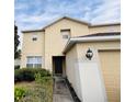 Two-story house with beige exterior, attached garage, and walkway at 32111 Brookstone Dr, Wesley Chapel, FL 33545