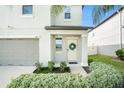 Front entryway with light beige door and wreath at 3873 Gainer Spring Avenue, New Port Richey, FL 34653