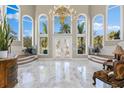 Grand two-story entry with marble floors and a large chandelier at 3025 Oakmont Dr, Clearwater, FL 33761