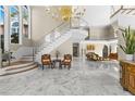 Elegant foyer with marble floors, staircase, and chandelier at 3025 Oakmont Dr, Clearwater, FL 33761