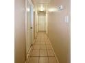 Long hallway with light walls and tile floors at 1001 N Park Rd, Plant City, FL 33563