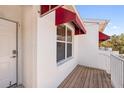 Private balcony with wood decking and red awning at 1420 Water View W Dr # 203, Largo, FL 33771