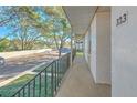 Private balcony overlooking parking lot with trees in background at 809 Russell Ln # 323, Brandon, FL 33510