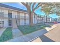 Two-story building with manicured landscaping and a large tree in front at 809 Russell Ln # 323, Brandon, FL 33510