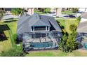 Home with a screened pool and patio, surrounded by lush landscaping at 11521 Lake Lucaya Dr, Riverview, FL 33579