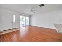 Bright living room with wood-look floors and sliding glass door access to patio at 1606 Berwick Ct # 10B, Palm Harbor, FL 34684