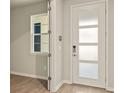 Bright entryway with modern door and wood-look floors at 12355 Hearts Ease St, Venice, FL 34293