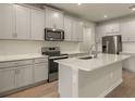 Modern kitchen featuring stainless steel appliances and an island at 12355 Hearts Ease St, Venice, FL 34293
