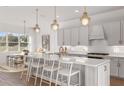 Modern kitchen featuring a large island and white cabinets at 13813 Sharp Hawk Dr, Riverview, FL 33569