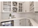 Butlers pantry with wine storage and quartz countertops at 13813 Sharp Hawk Dr, Riverview, FL 33569
