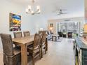 Dining area with a wooden table and chairs, adjacent to the living room at 1435 Millstream Ln # 202, Dunedin, FL 34698