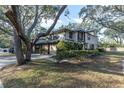 Two-story townhouse with green metal roof and lush landscaping at 1510 Mahogany Ln # 606, Palm Harbor, FL 34683