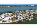 Aerial view showing waterfront homes, private docks, and boats along the scenic coastline at 807 Bay Point Dr, Madeira Beach, FL 33708