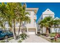 Two-story home with palm trees and a paved driveway at 140 Brightwater Dr # 6, Clearwater Beach, FL 33767