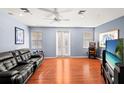 Game room with leather couch, large TV, and access to balcony at 3010 Bayshore Pointe Dr, Tampa, FL 33611