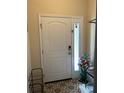 Interior entryway with white door and tile flooring at 844 Callista Cay Loop, Tarpon Springs, FL 34689