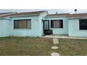 Light blue single story home with small front yard at 205 163Rd Ave, Redington Beach, FL 33708