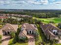 Aerial view of home and neighborhood, backing to golf course and mature trees at 4825 Benito Ct, Bradenton, FL 34211