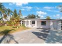 Newly renovated home with white exterior, landscaping, and driveway at 6318 S Renellie Ct, Tampa, FL 33616