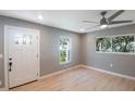 Light gray walls, hardwood floors, ceiling fan, and white door at 6318 S Renellie Ct, Tampa, FL 33616