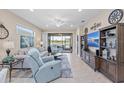 Relaxing living room with a view of the lanai and plenty of natural light at 20644 Swallow Tail Ct, Venice, FL 34293