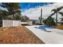 Home's exterior showcasing a driveway and white fence at 3501 63Rd N St, St Petersburg, FL 33710