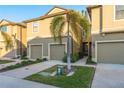 Tan two-story townhome with a two-car garage at 5162 Bay Isle Cir, Clearwater, FL 33760