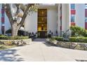 Inviting condo entrance with beautiful stonework, lush plants and seating at 2650 Pearce Dr # 301, Clearwater, FL 33764