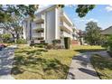 Picture of the side exterior of the condo, with balconies and green space at 2650 Pearce Dr # 301, Clearwater, FL 33764