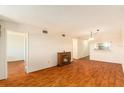 Spacious living room featuring wood floors, an electric fireplace, and a glimpse of the kitchen at 801 83Rd N Ave # 511, St Petersburg, FL 33702