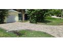 Newly paved driveway with a drainage system at 105 Causeway Blvd, Belleair Beach, FL 33786