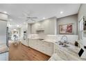 Bright kitchen with white cabinets, marble countertops, and stainless steel appliances at 418 Cardiff Rd, Venice, FL 34293