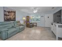 Bright living room with tile floors, recliner, and large TV at 5216 81St N St # 3, St Petersburg, FL 33709