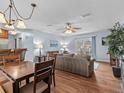Bright dining area with wood table and chairs, adjacent to kitchen at 709 Mandalay Ave, Clearwater Beach, FL 33767