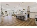 Open concept kitchen with white cabinets, an island, and stainless steel appliances at 4501 21St N St, St Petersburg, FL 33714