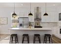 Modern kitchen with white cabinets, a large island, and gold accents at 4501 21St N St, St Petersburg, FL 33714